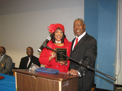 Mrs. James receives an award from Dr. Myland Brown author of Pure Butter